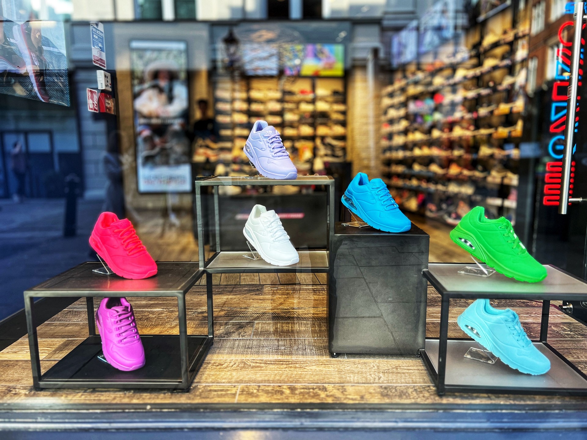 Multi coloured trainers in shoe store window