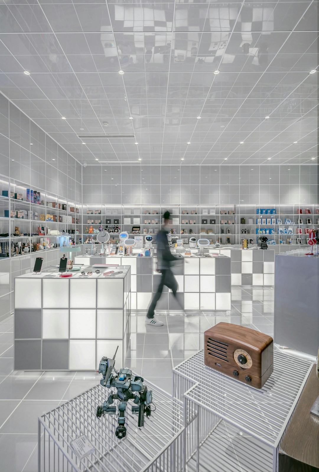 man walking beside white cube decoration